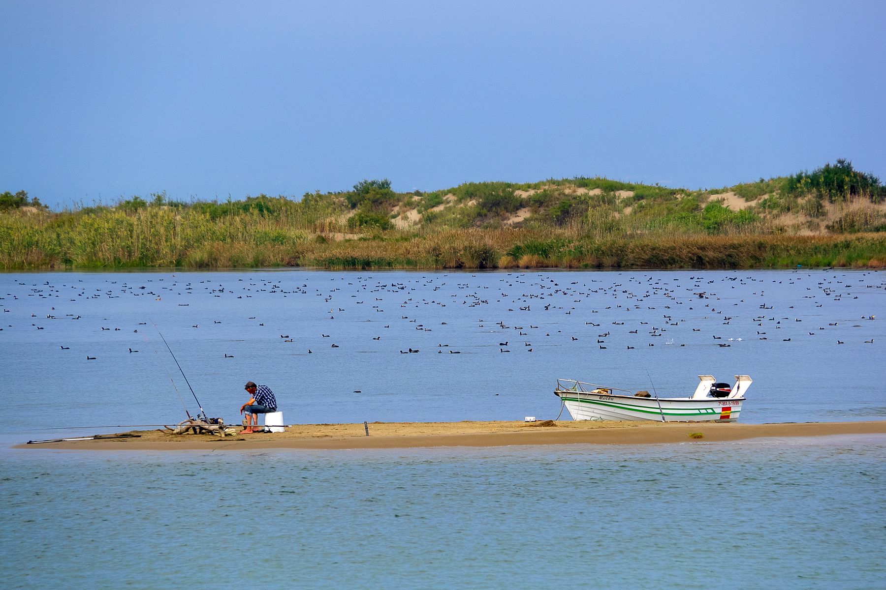 Angler beside a small boat