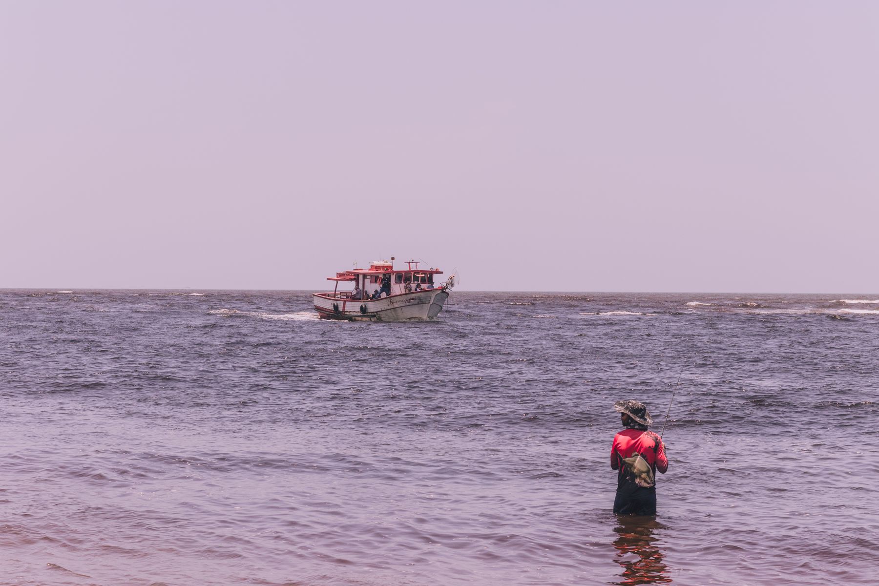 Angler wading in coastal water